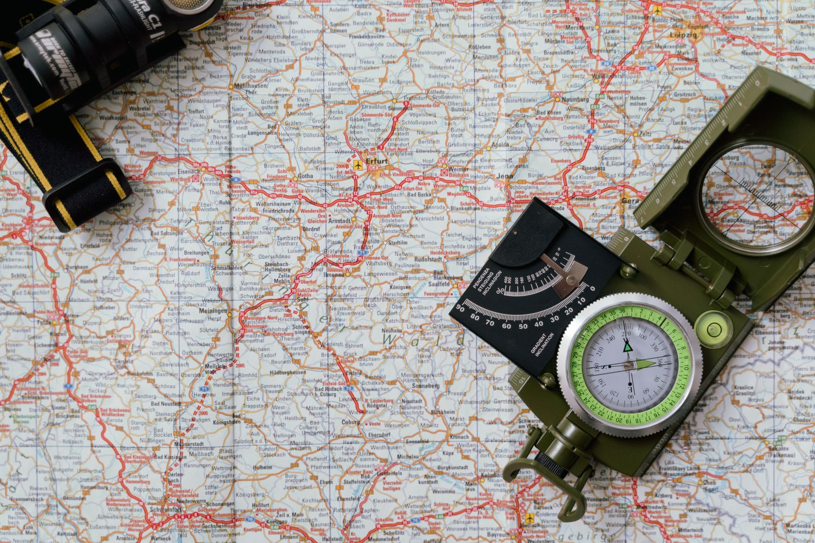 A compass resting on an open map